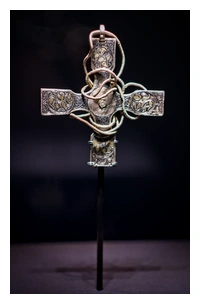 A cross with a chain wrapped around it.