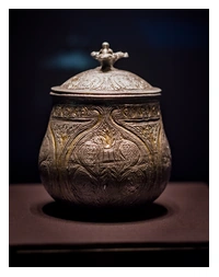 A silver vessel with a lid